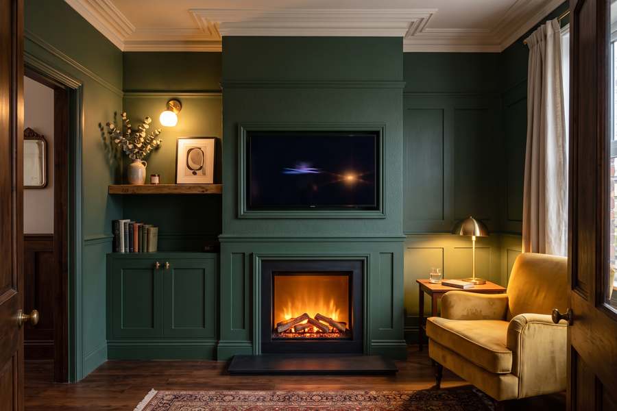 A panelled media wall with an inset fire, display alcoves and closed cupboards along the base